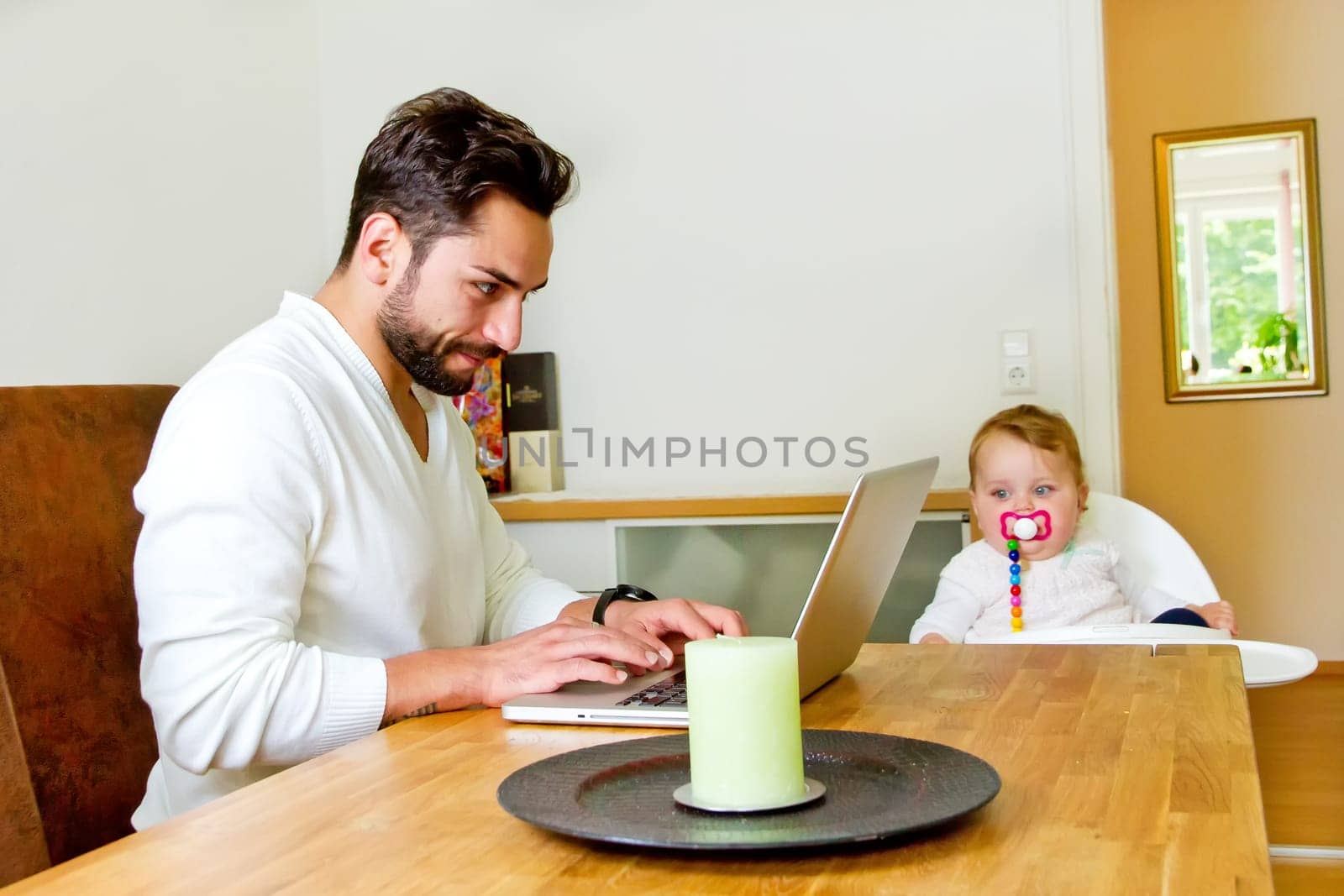 Father works at home on the computer