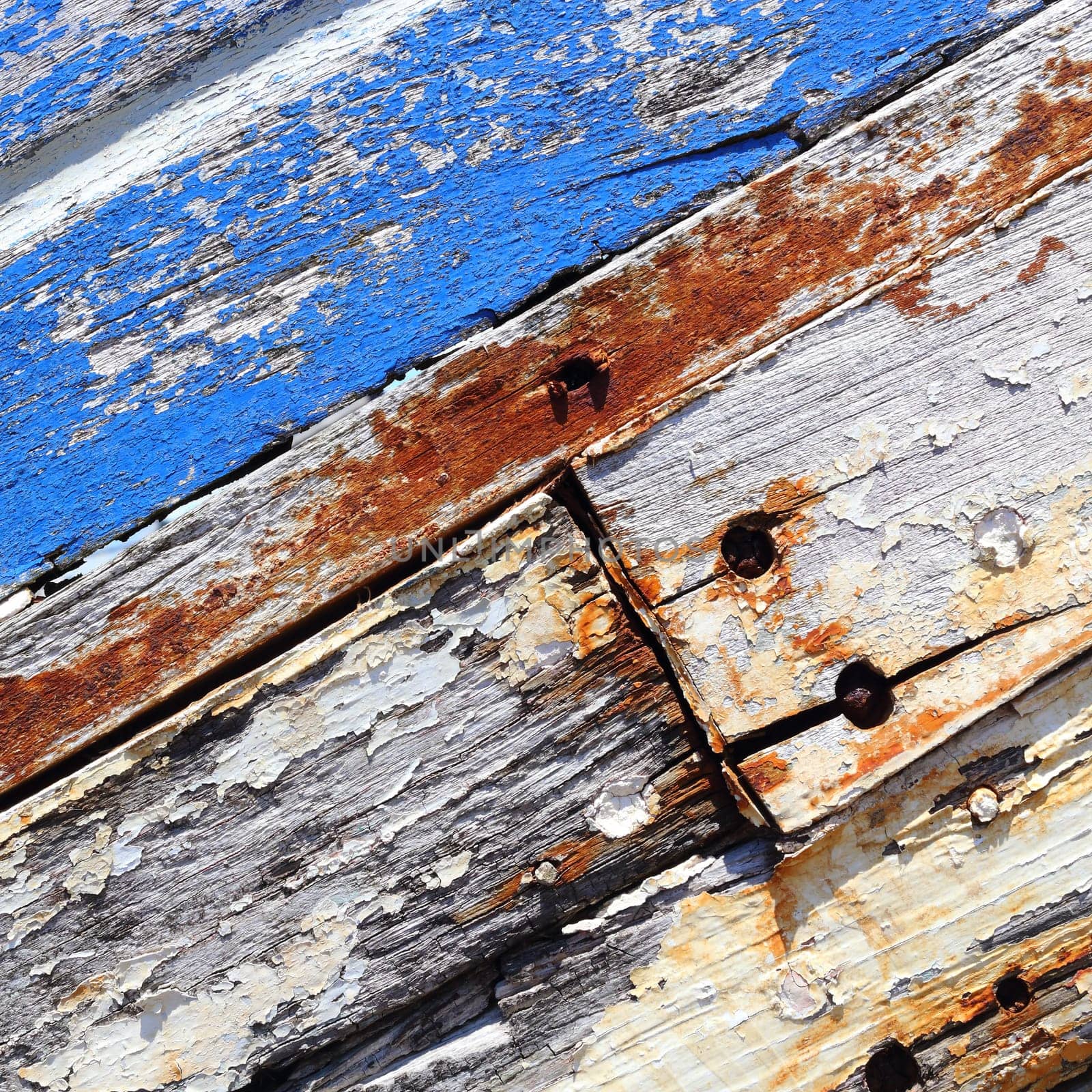 Boards of old boat with peeling paint background texture