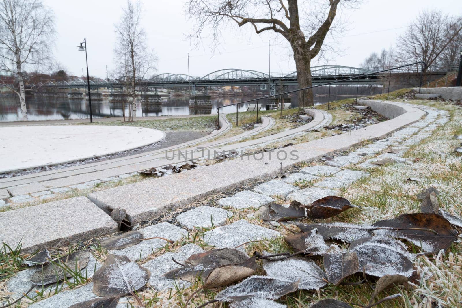 Bridge in Umeå, Sweden with leaves and river.