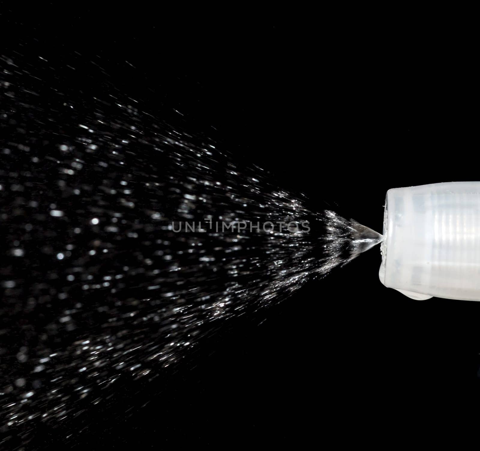 Water Spray Nozzle spraying water with a black background behind it.