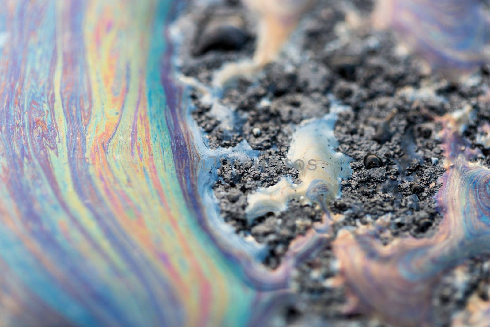 Gasoline Spill on Asphalt close u macro image.
