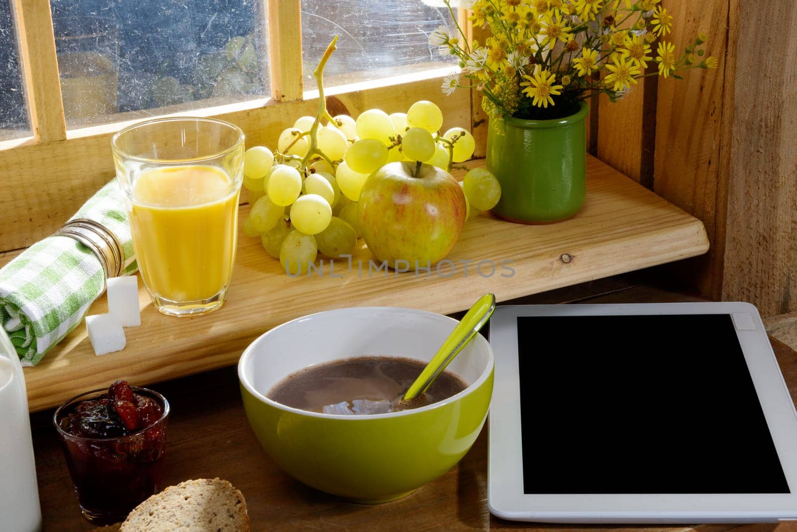 French breakfast with digital tablet, near the window