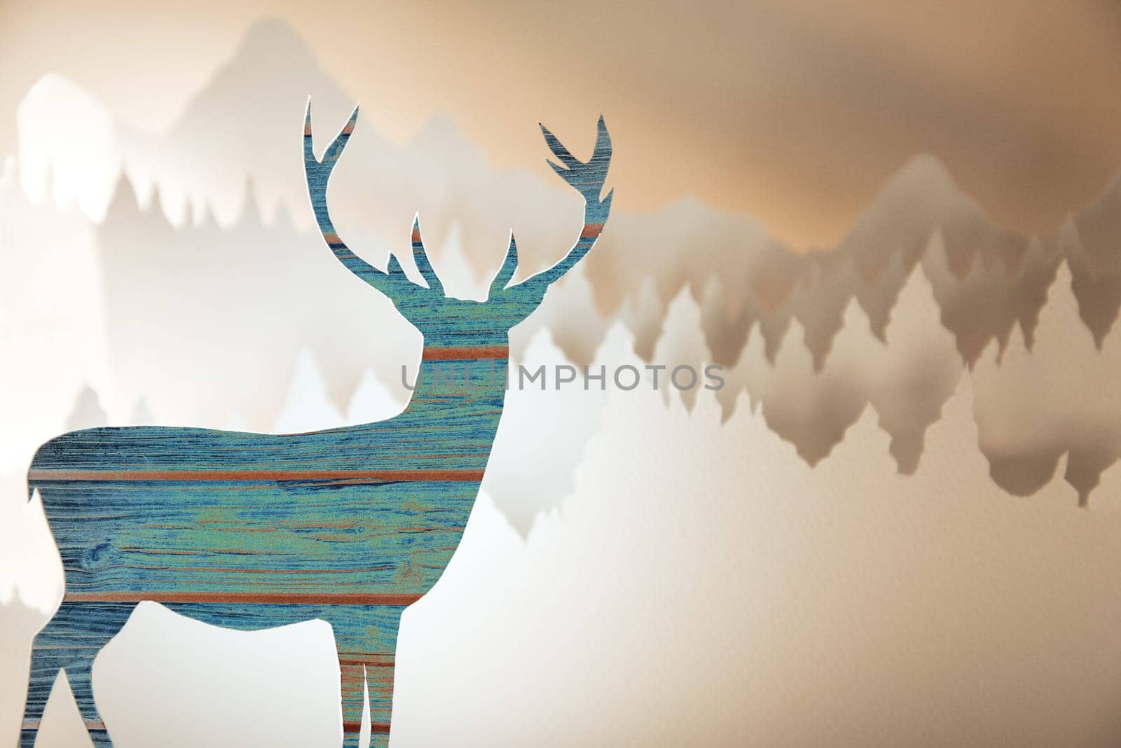 Merry christmas new year handmade paper cut greeting card with wood pattern deer silhouette and winter forest landscape background.