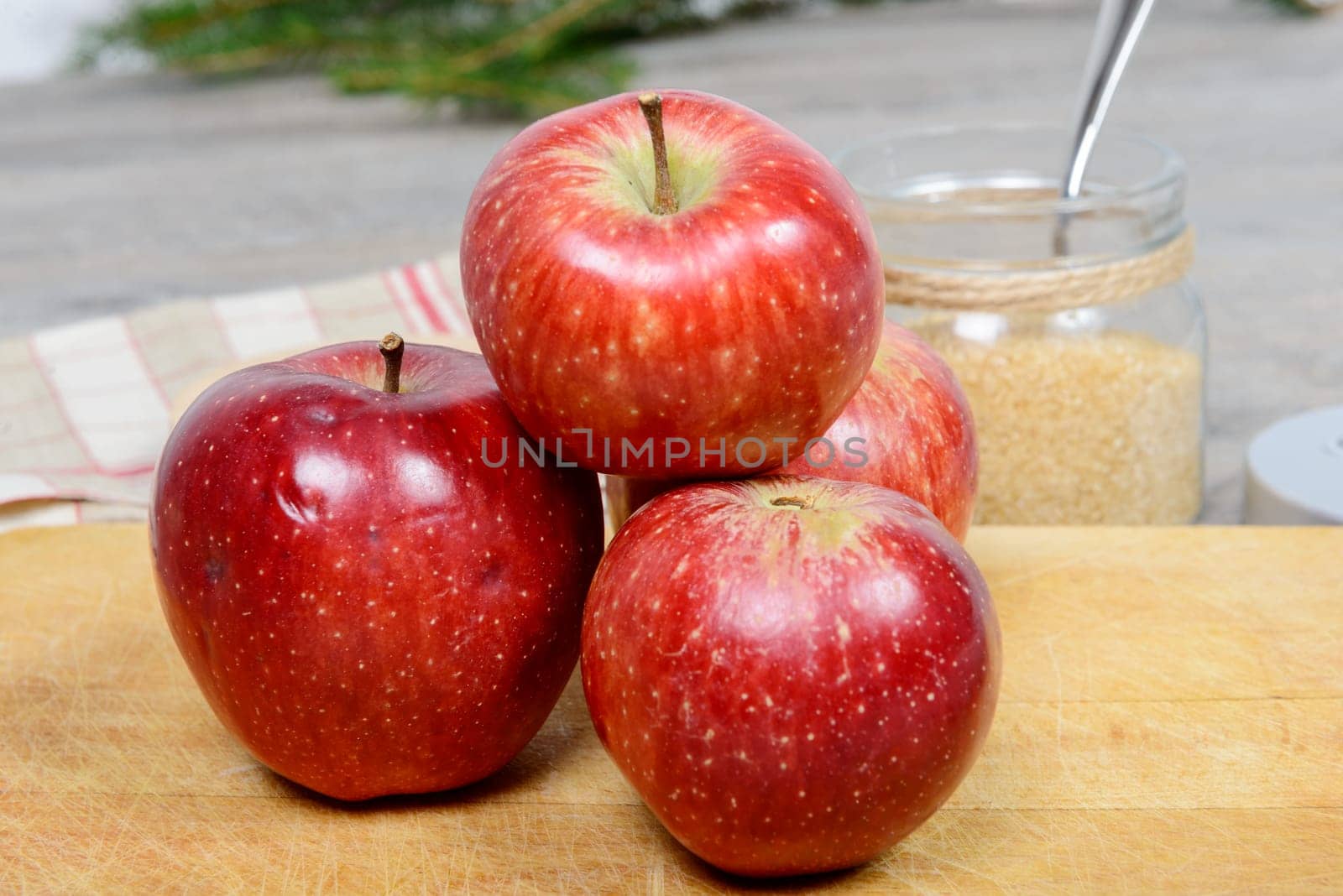 several beatiful red apples on a wooden background
