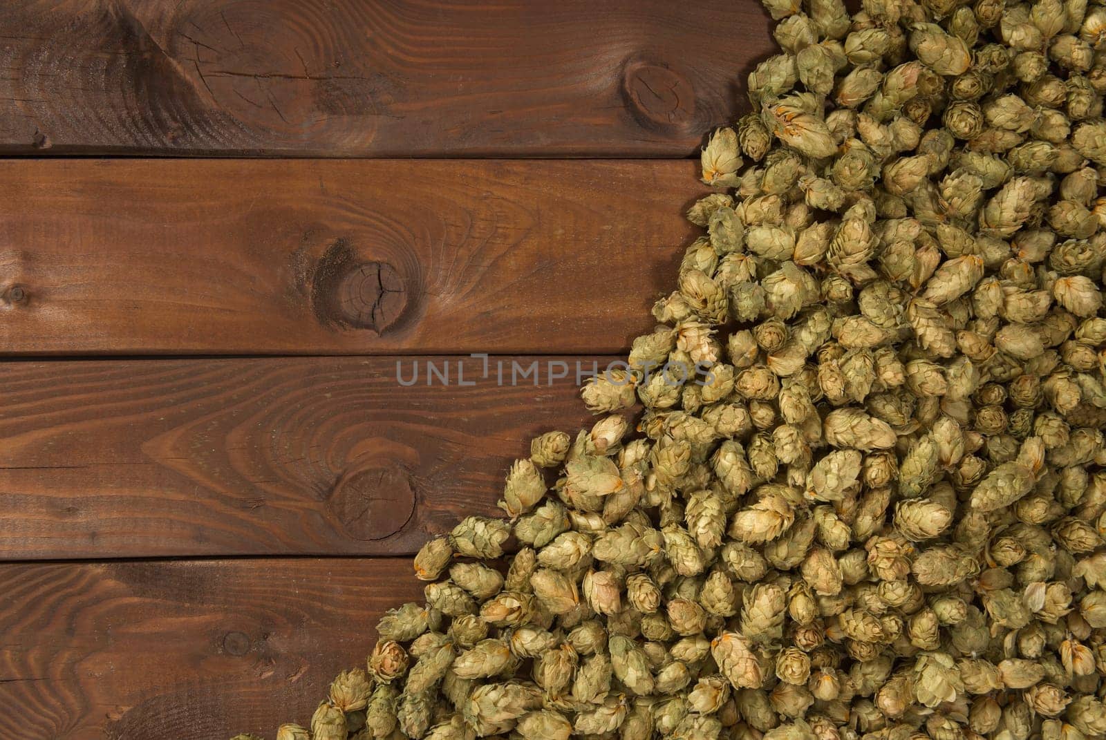 many dried hop cones on old weathered wooden boards