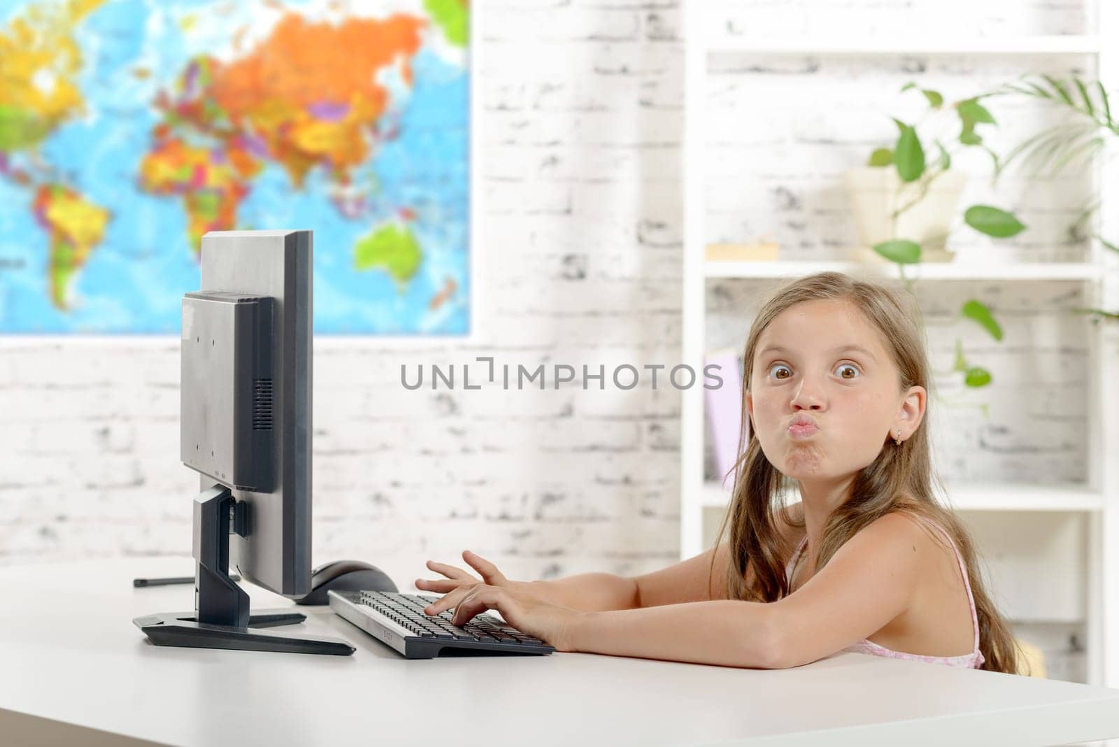 a young school girl grimaces in the classroom