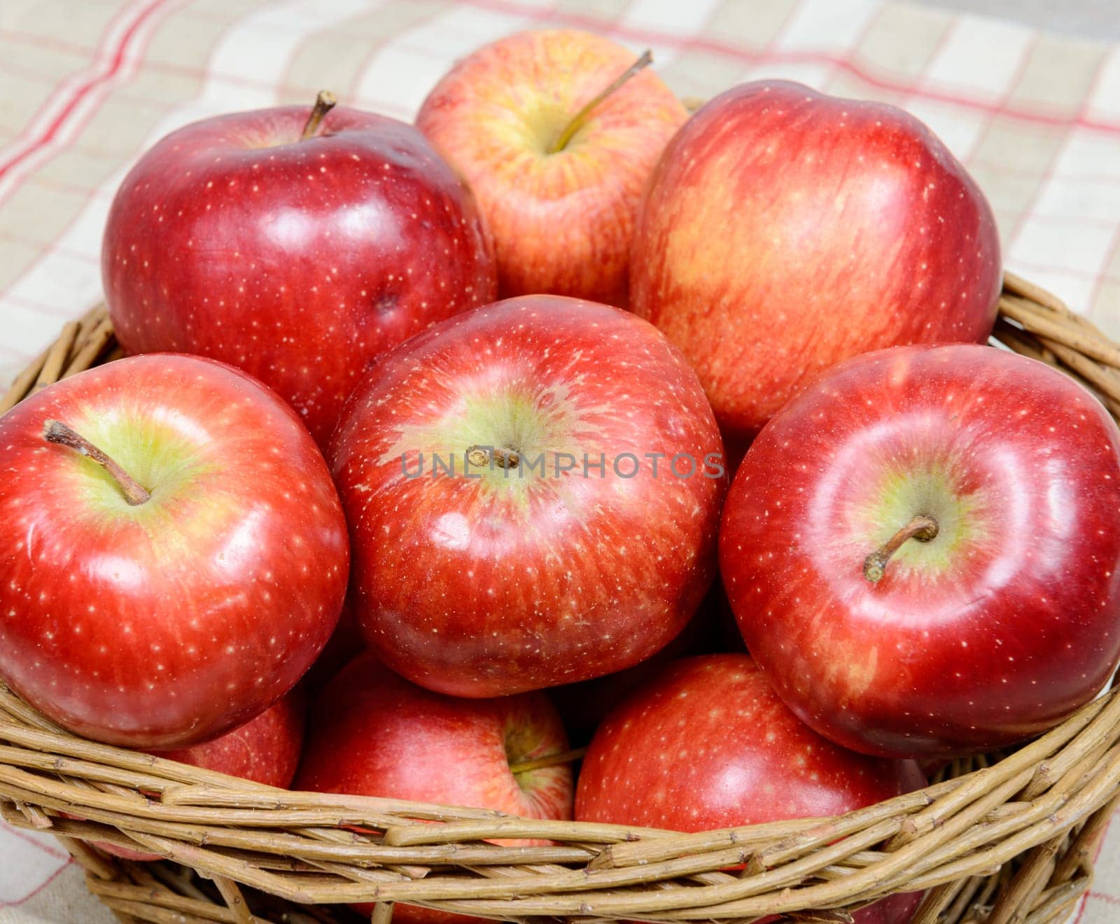 Several red apples in a basket wicker