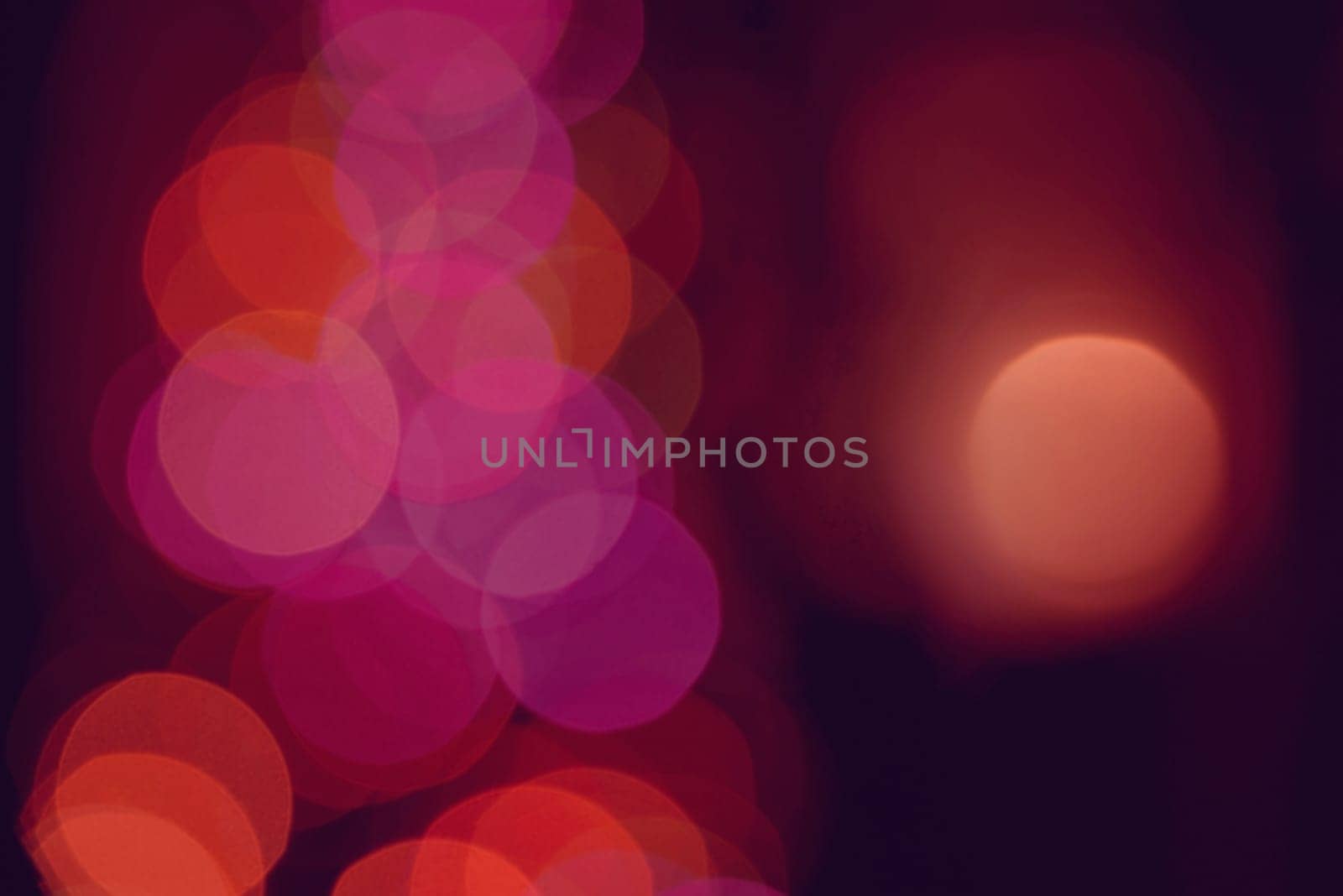 Defocused blur lights background closeup with bokeh effect. Ideal for holiday greeting card, event, or web backdrop.