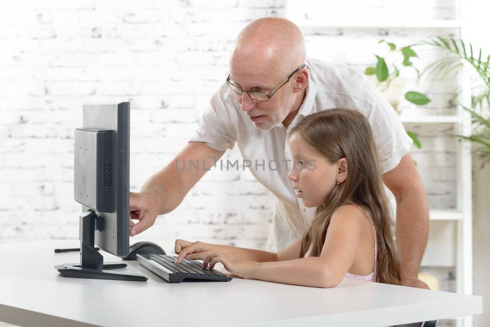 a teacher and a school girl with a computer