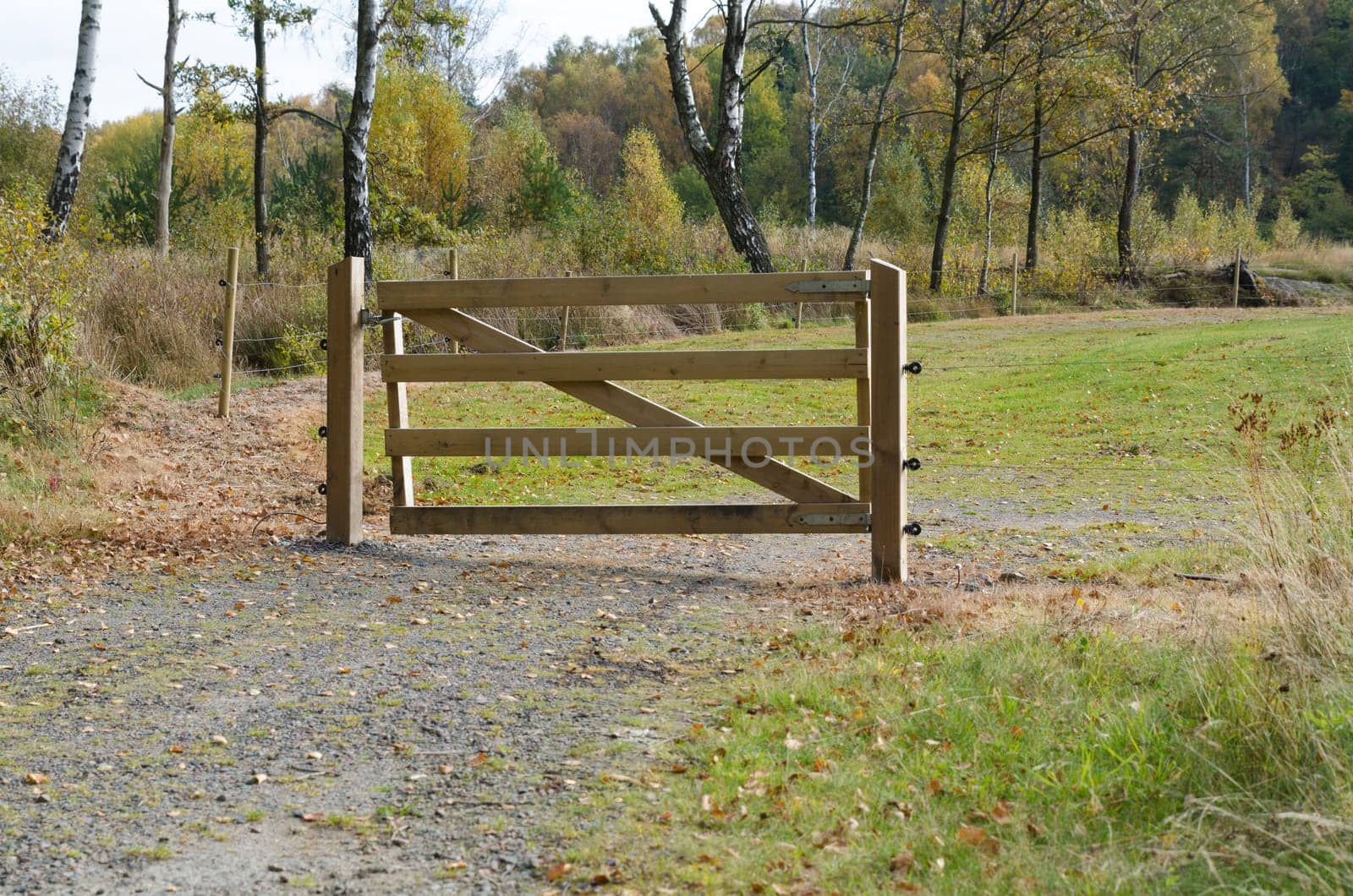 a gate of wood to protect the golfcource from animal