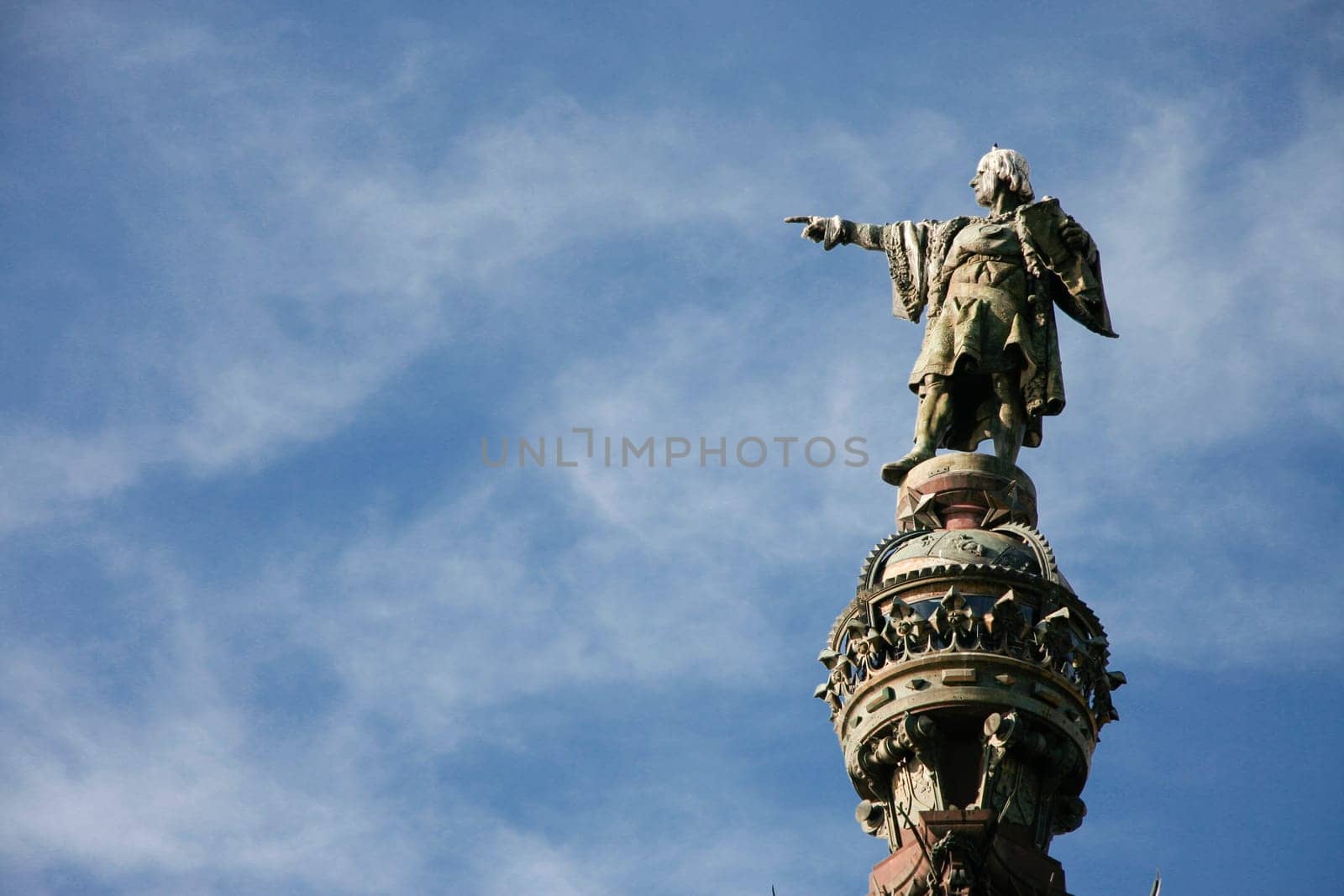 Monument of Christopher Columbus pointing towards America  in Barcelona, Catalonia, Spain. Isolated over blue cloudy sky