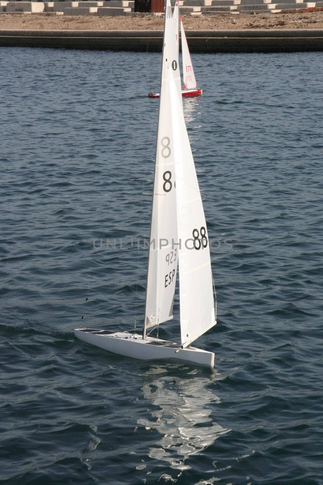 BARCELONA, SPAIN - DEC 29, 2007: People racing remote controlled sailing wooden yachts at Forum Port
