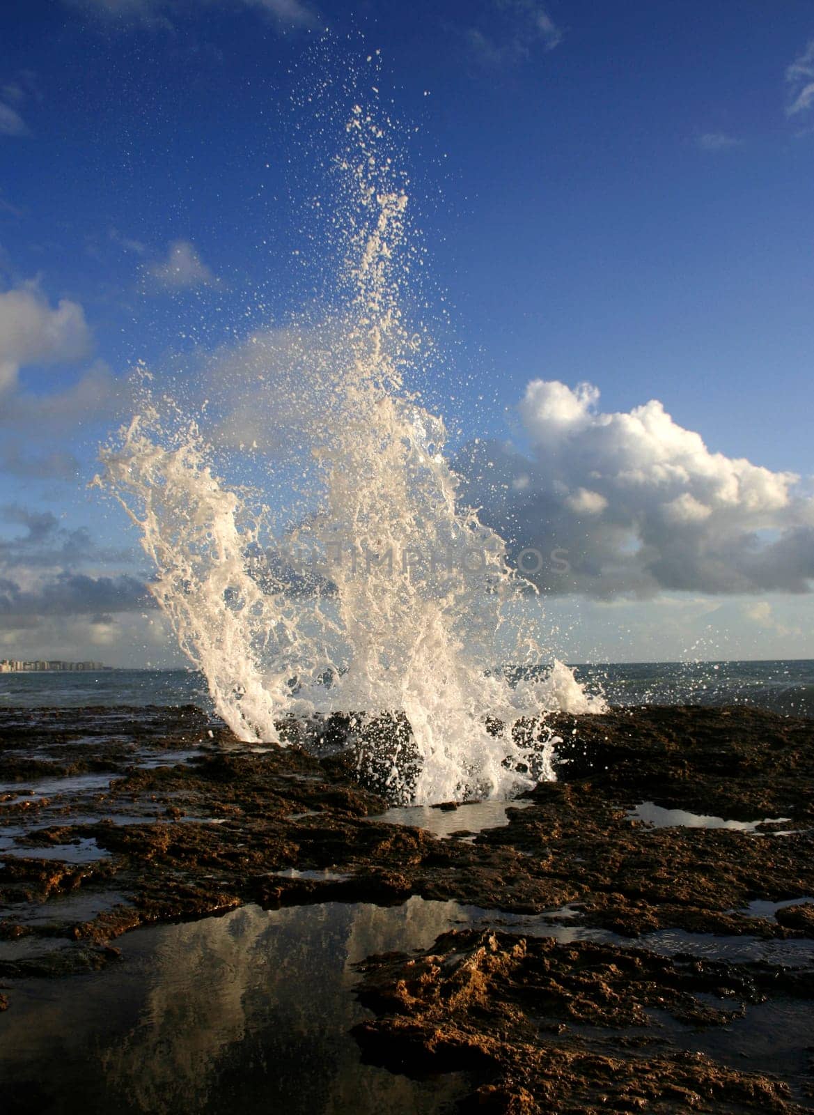 blow hole on Cadiz coastline sending two burst of water high into the air, Spain
