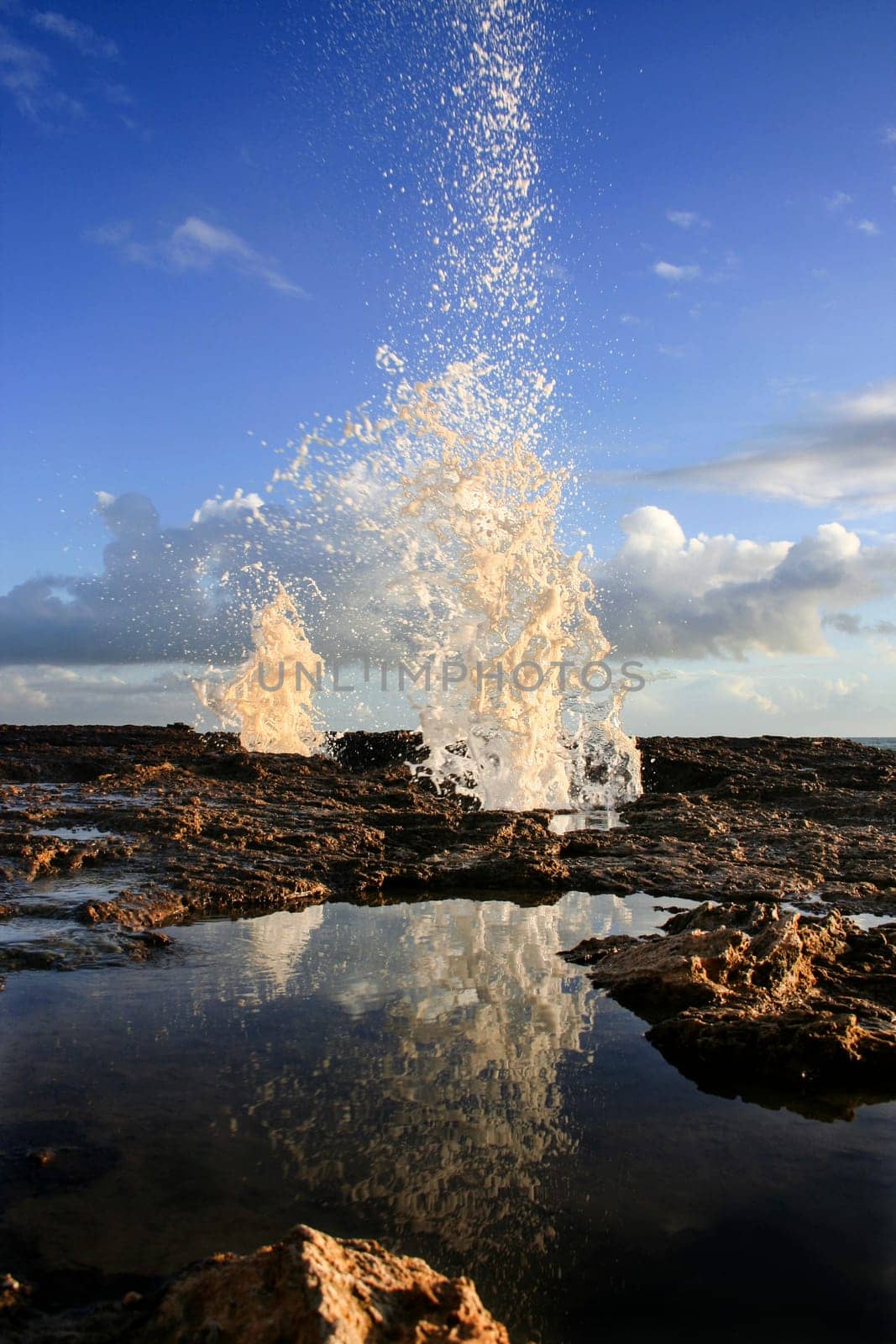 blow hole on Cadiz coastline sending two burst of water high into the air, Spain