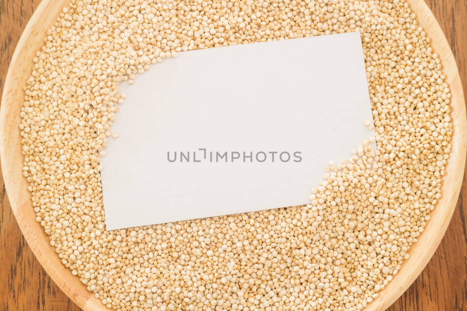 Organic quinoa grain and business card, stock photo