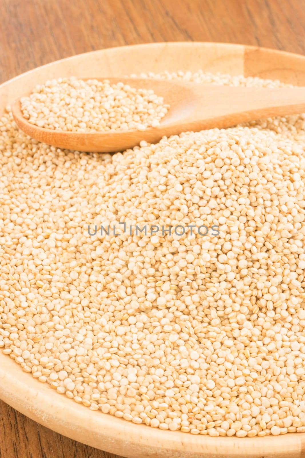Quinoa grain in wooden plate, stock photo