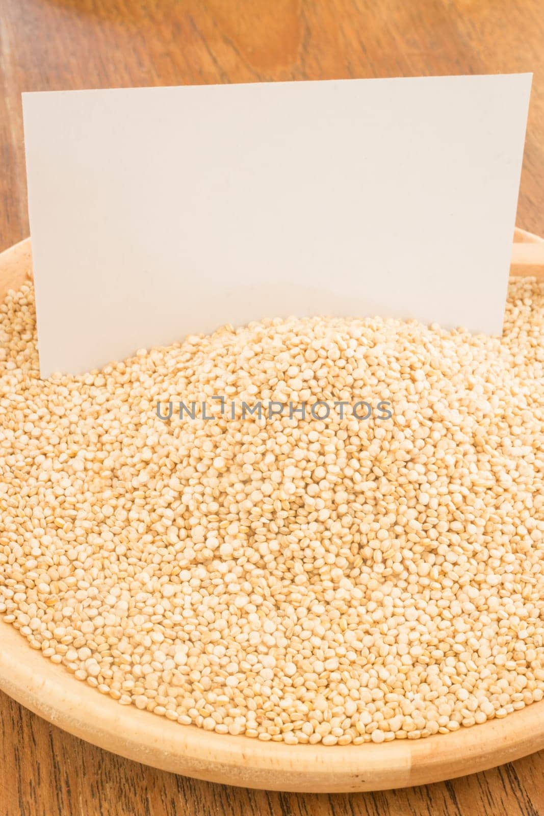 Organic quinoa grain and business card, stock photo