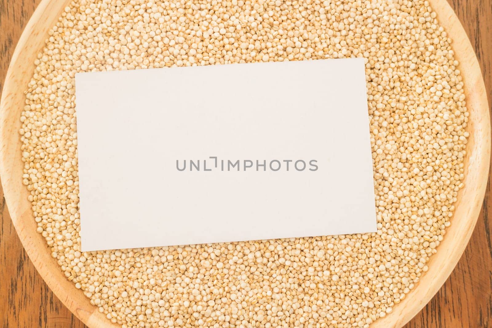 Organic quinoa grain and business card, stock photo