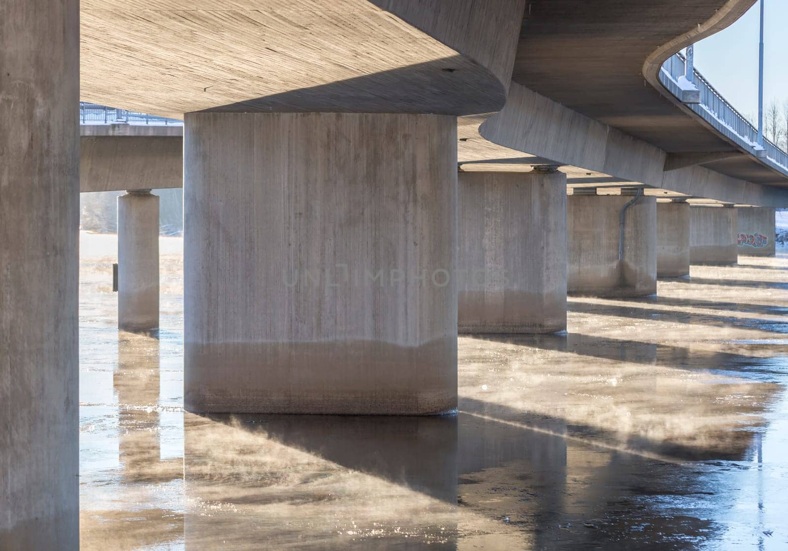 Mist on Icy River under Bridge in Umea, Sweden