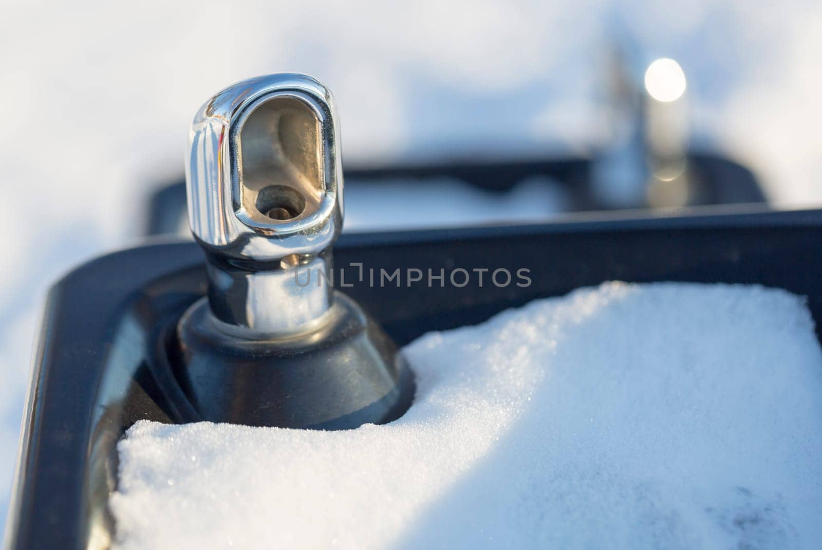 Drinking fountain with Snow and white/grey background.