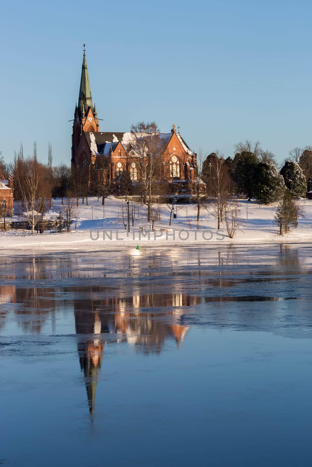 Church in Umeå, Sweden with clear blue sky and some ice on the river.