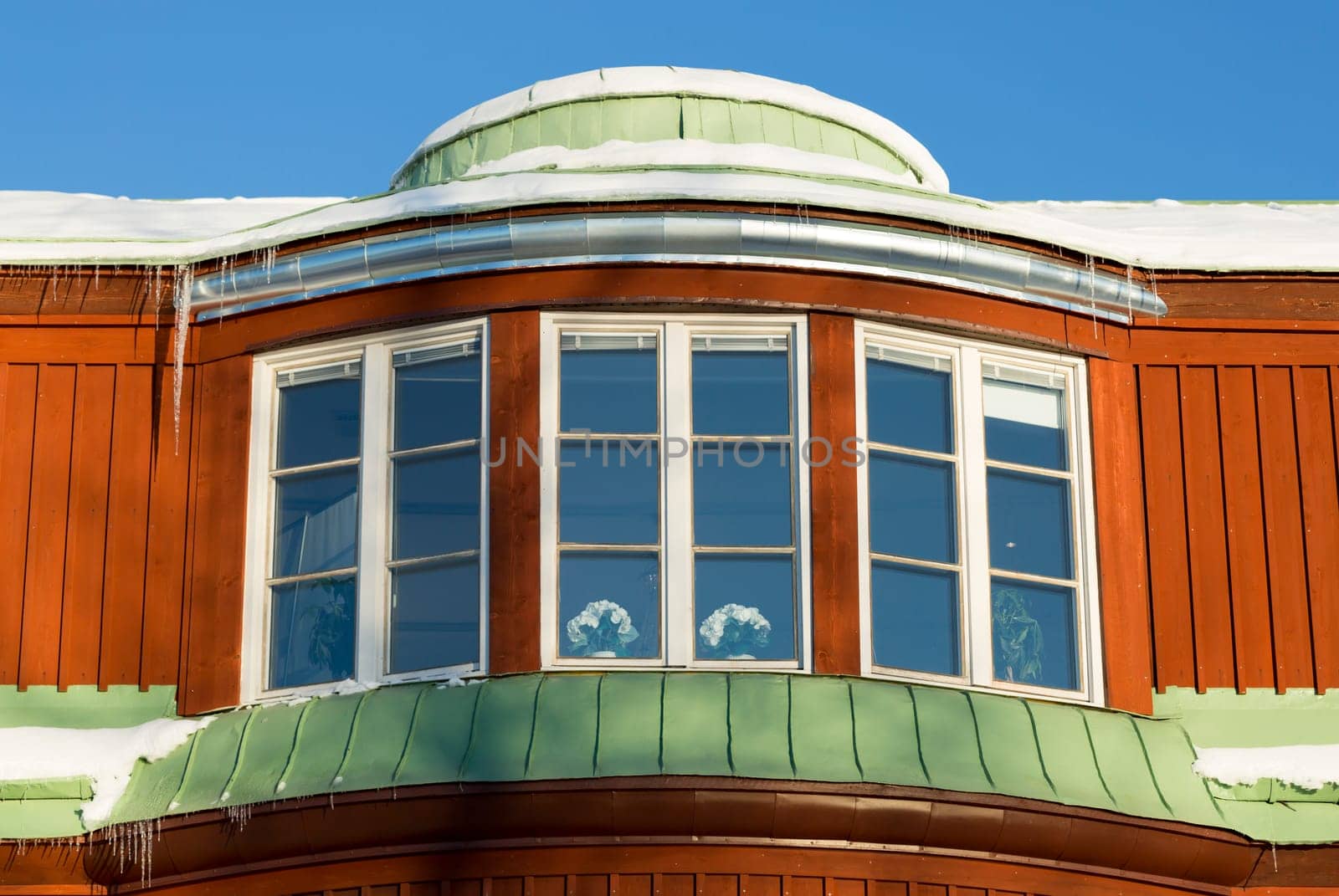 Building with Icicles and Snow with a clear blue sky.