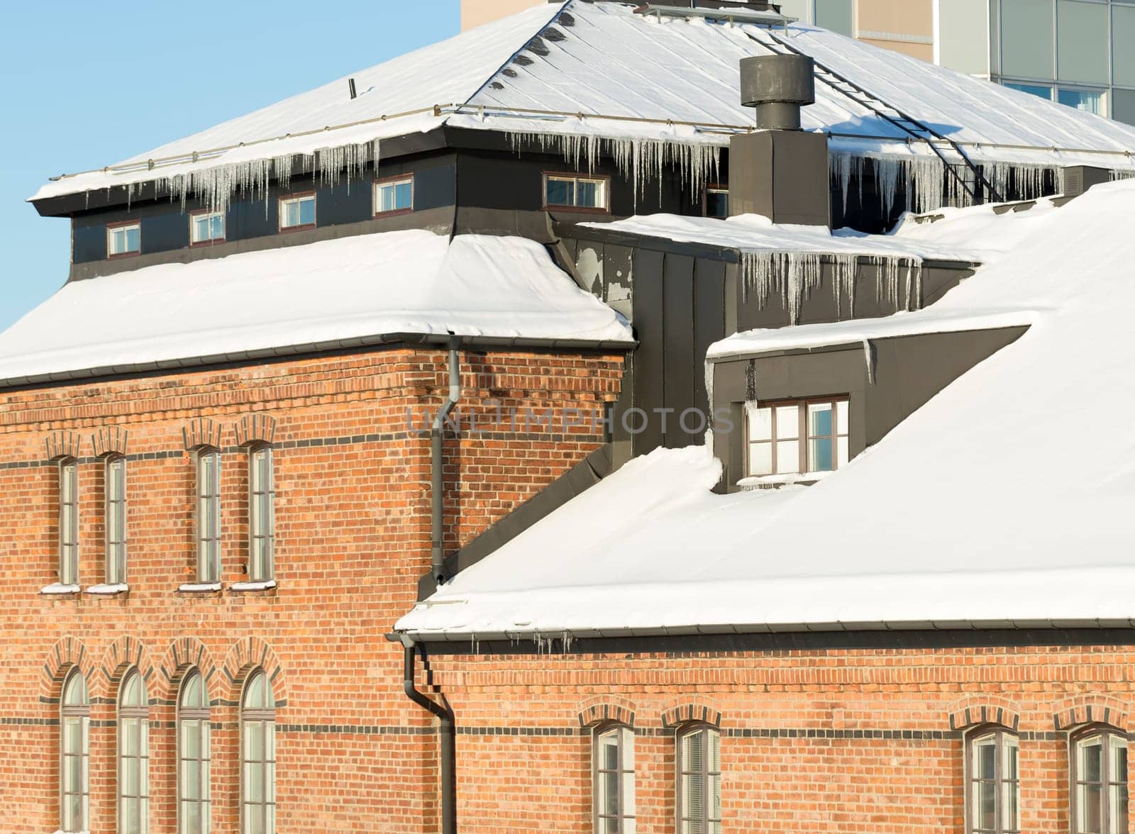 Icicles Hanging from Roof with snow in winter.