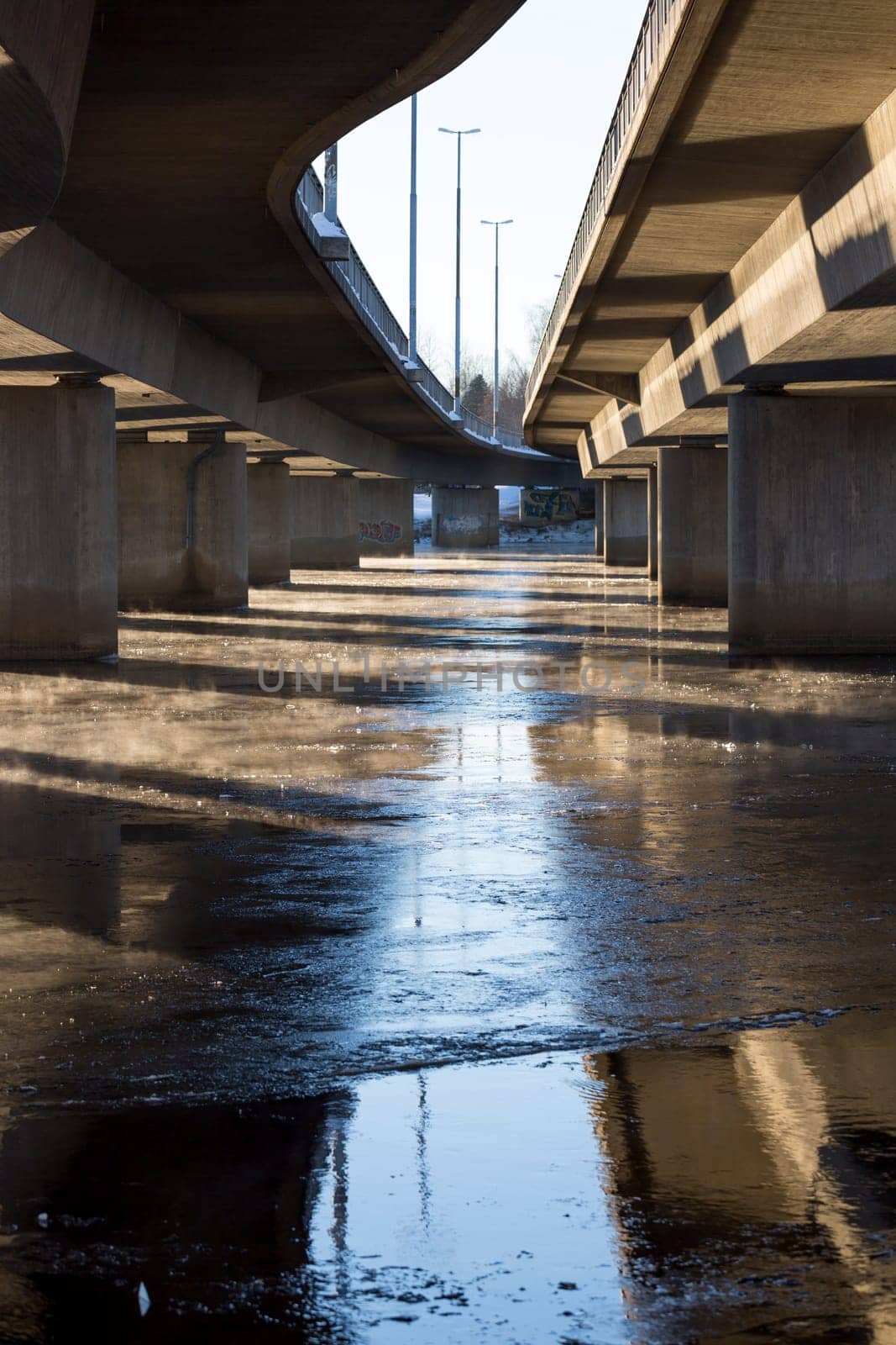 Mist on Icy River under Bridge in Umea, Sweden