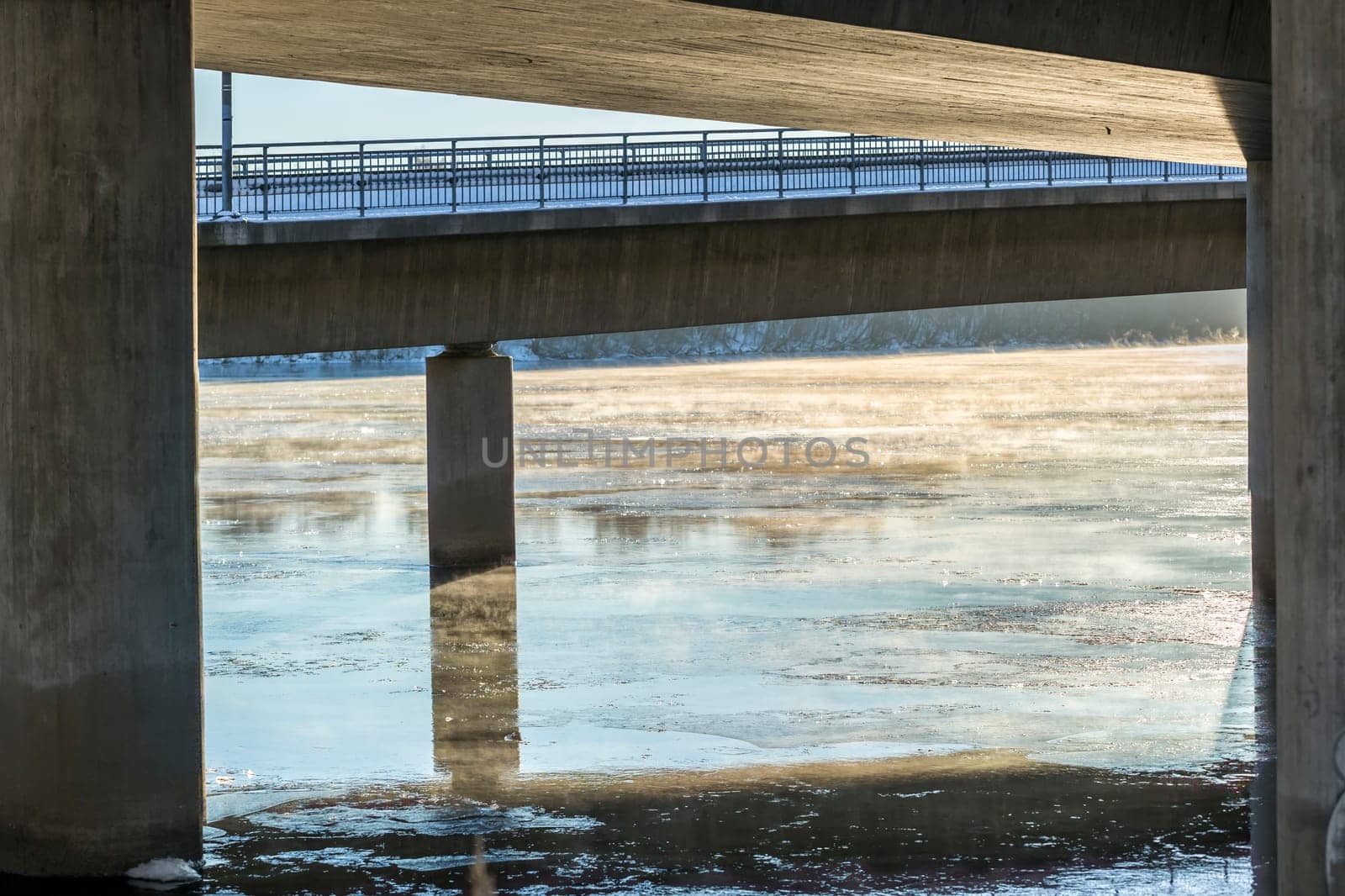 Mist on Icy River under Bridge in Umea, Sweden