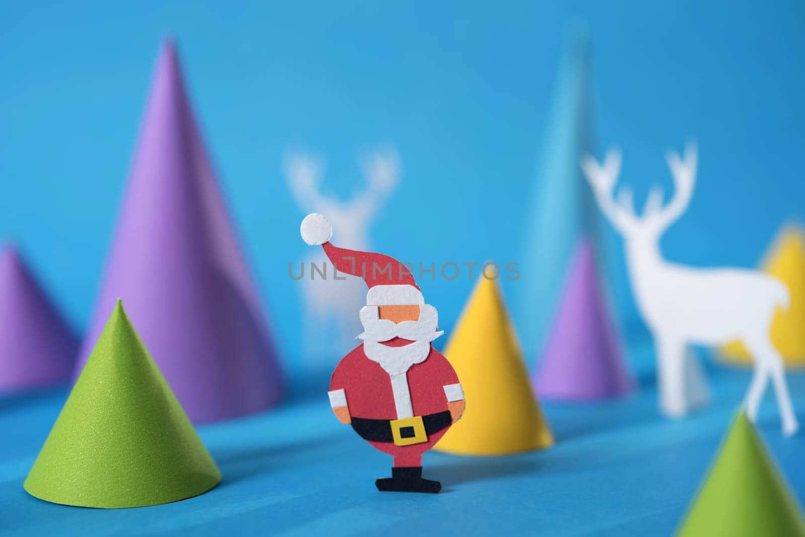 Merry Christmas 3d paper cut design with handmade santa, Xmas pine tree shapes and deer silhouettes. Ideal for holiday greeting card, poster or web.    .