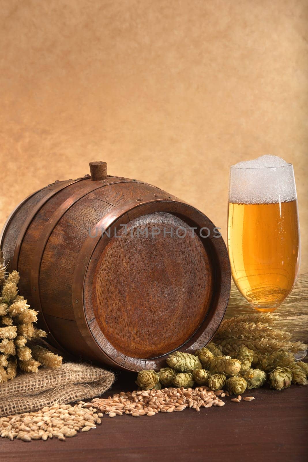 Old wooden barrel with beer glass,wheat,barley,hops and malt