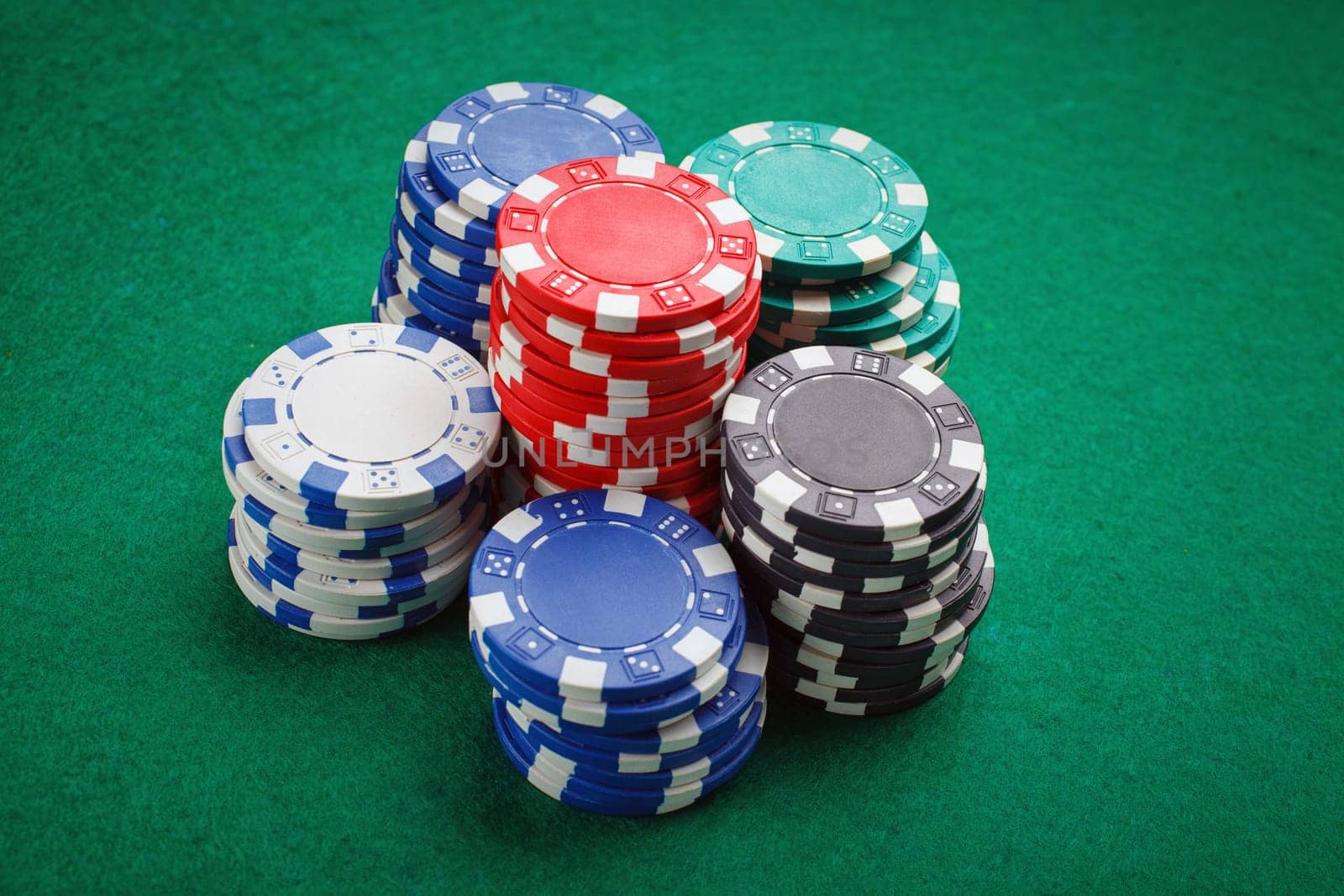 chips for poker on green playing table