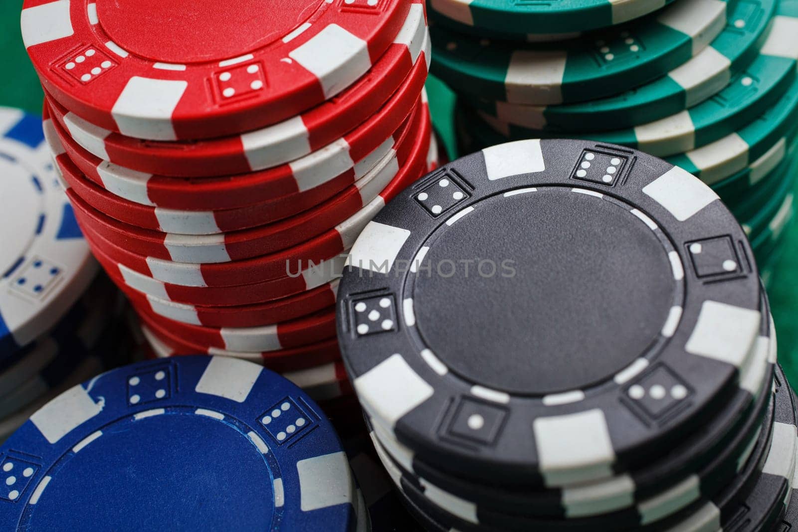 chips for poker on green playing table