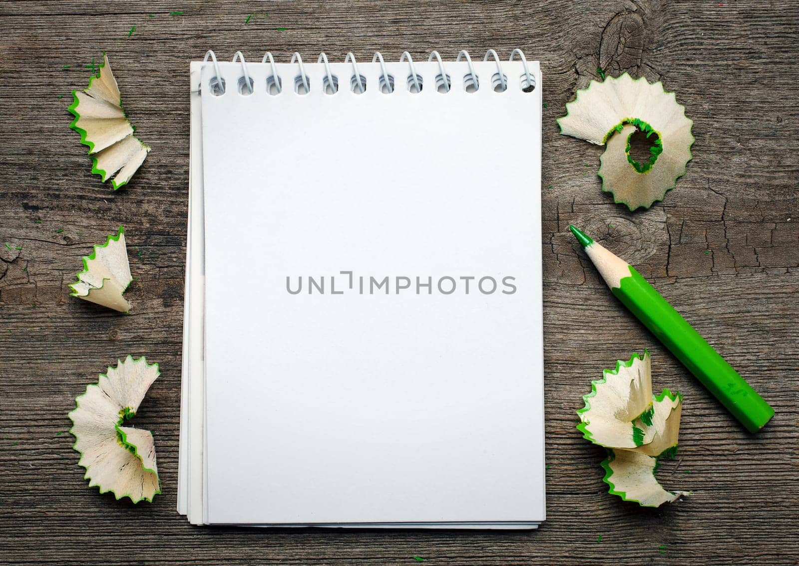 notebook with pensil on wooden background