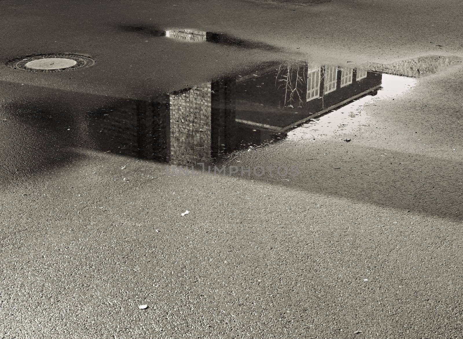 Reflection of a building in a puddle