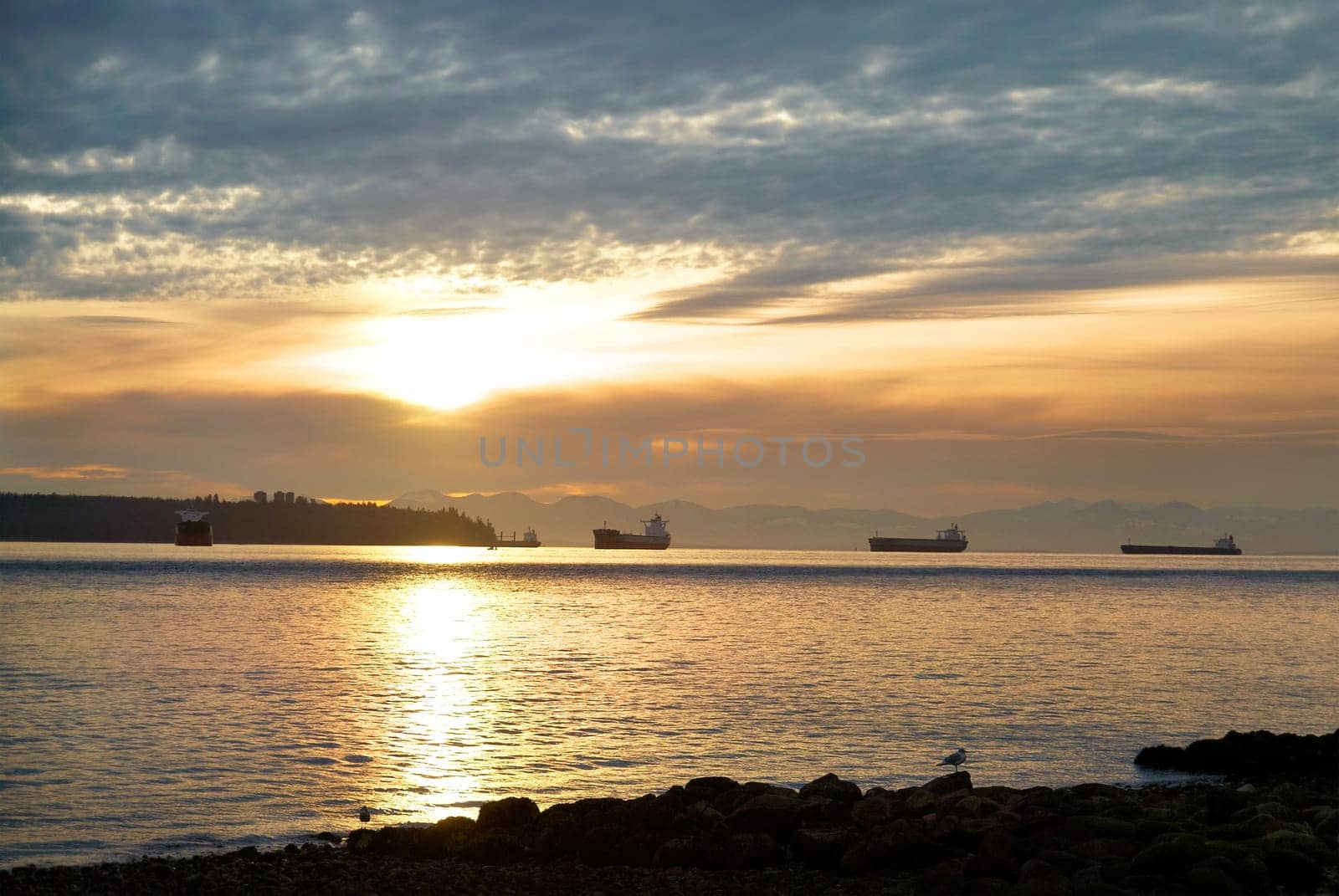 Sunset on the sea. Coastline and beautiful cloudscape.