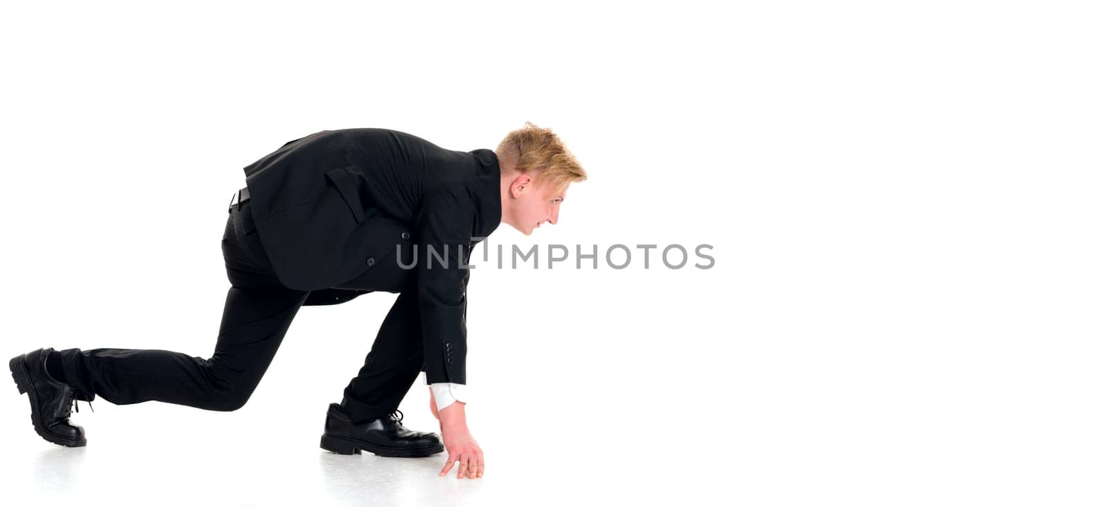 young businessman in black suit in start position