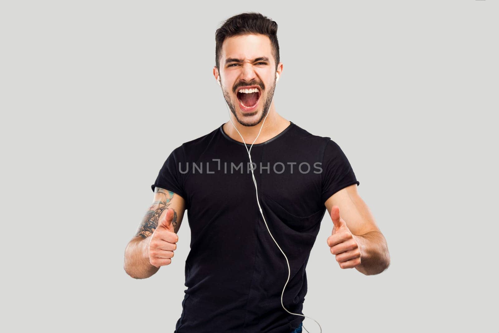 Beautiful and happy latin man listen music with thumbs up