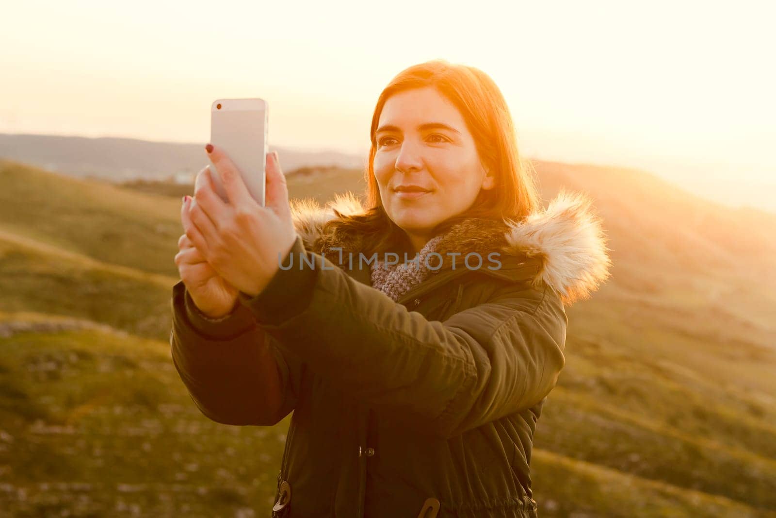 Beautiful woman in outdoor making a selfie