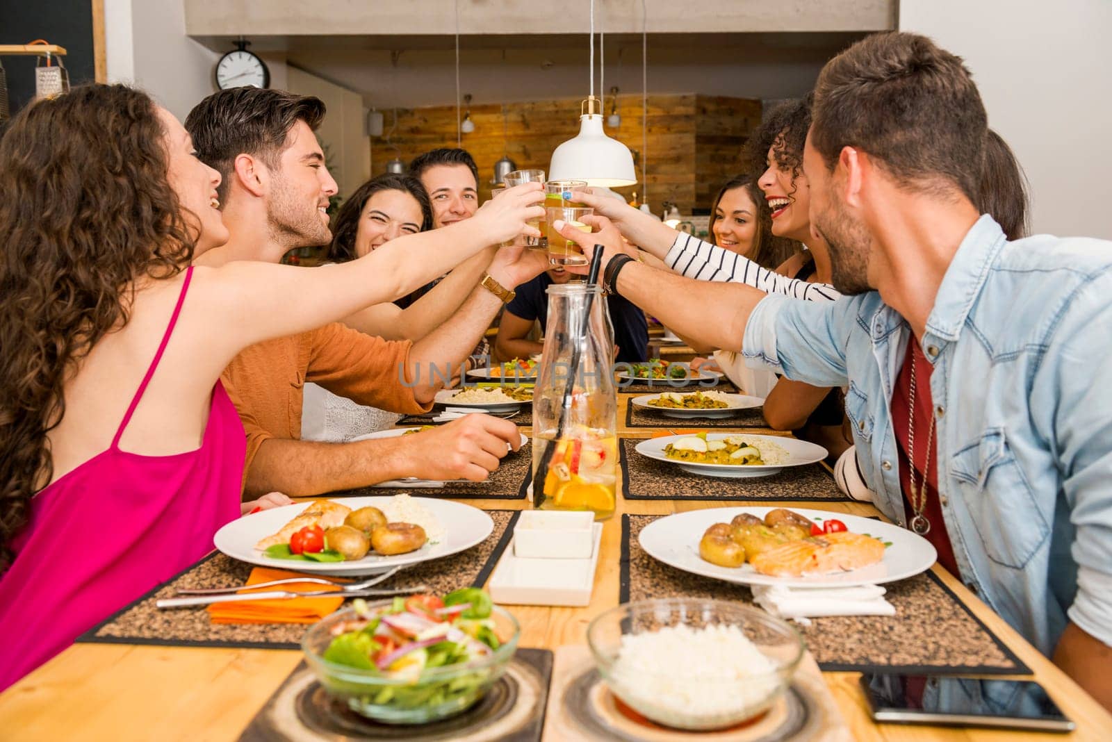 Multi-Ethnic Group of happy friends lunching and tasting the dessert at the restaurant