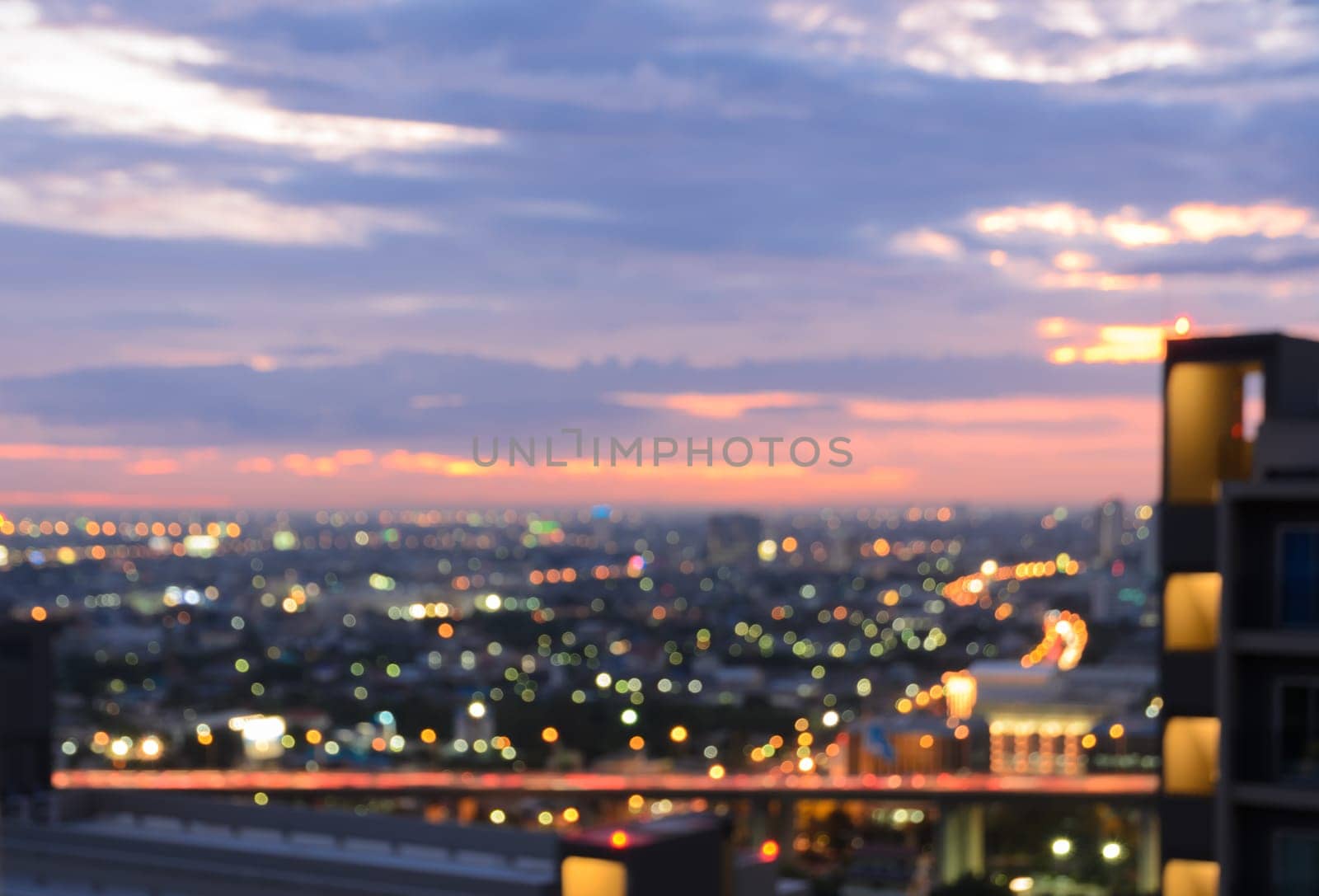 Colorful blurred skyscrapers with city bokeh lights illuminated at twilight
