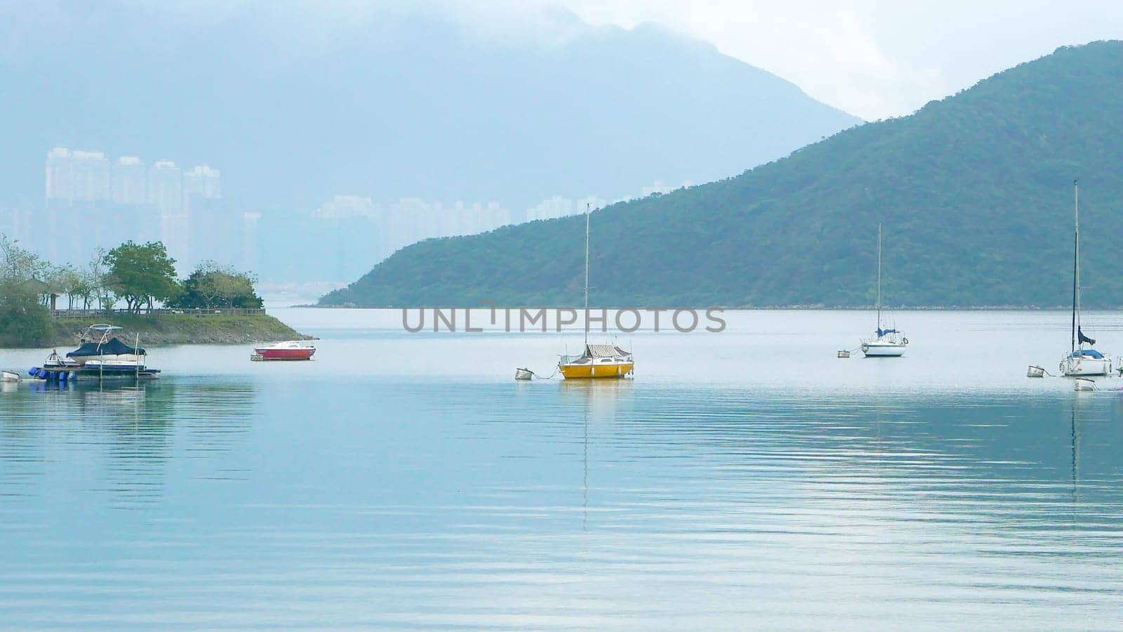 few sailboats on the peaceful lake