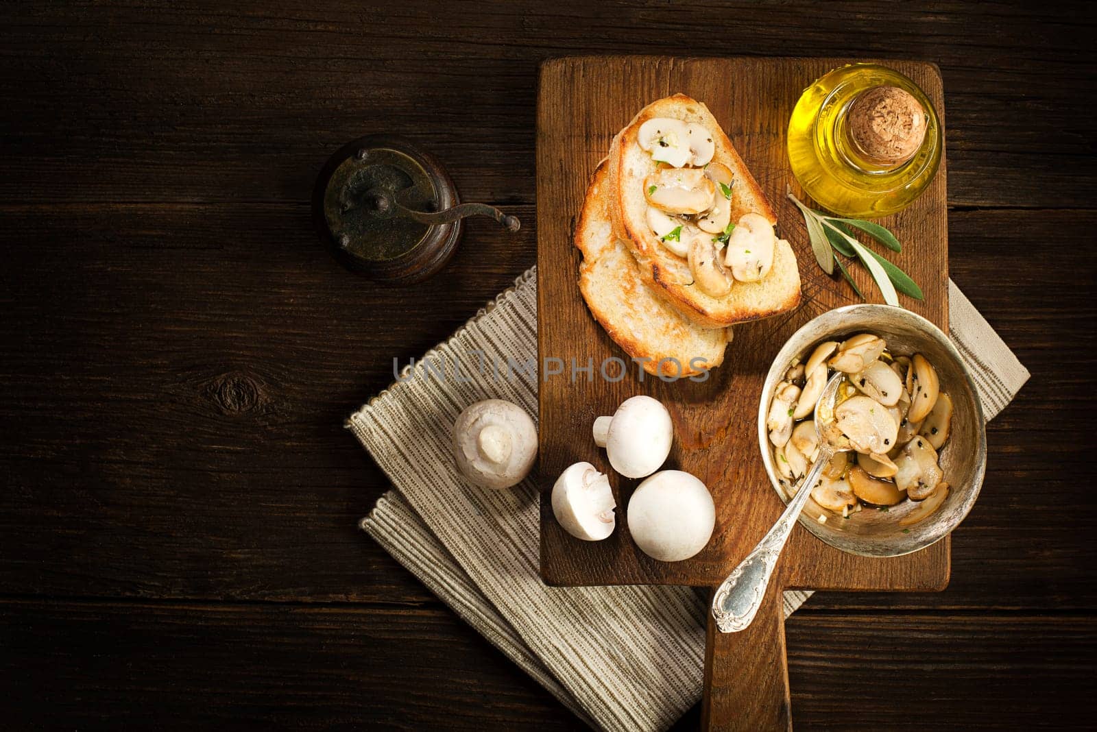 Appetizer Bruschetta with sauce of olive oil, mushrooms and herbs.