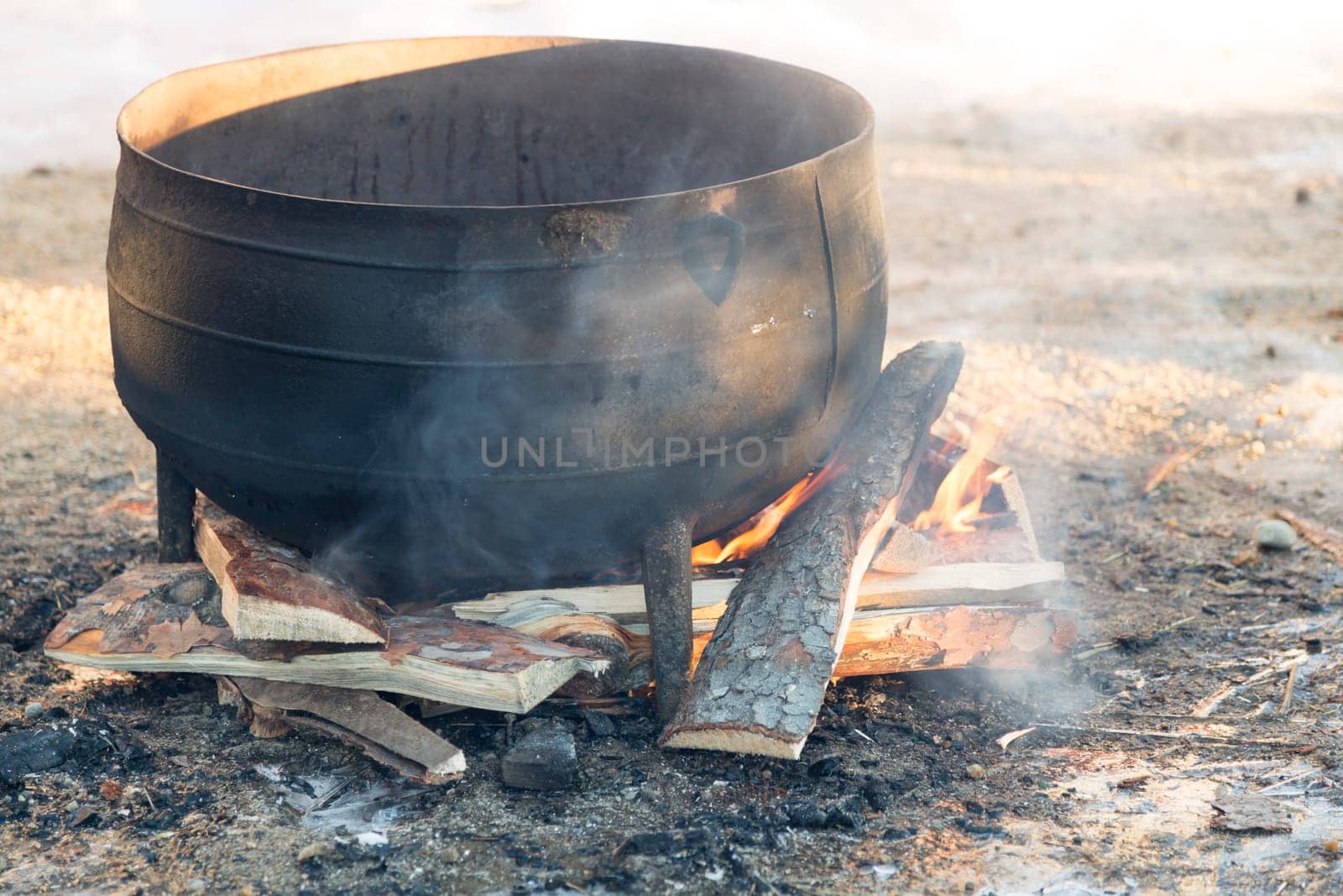 Black kettle on fire pit.