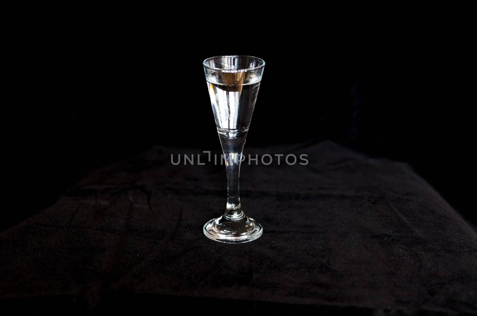 a cold shot in a black background ready to drink