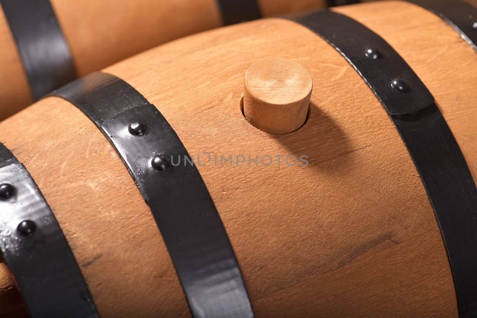 Close-up of old beer barrels with wooden plugs on a wooden background