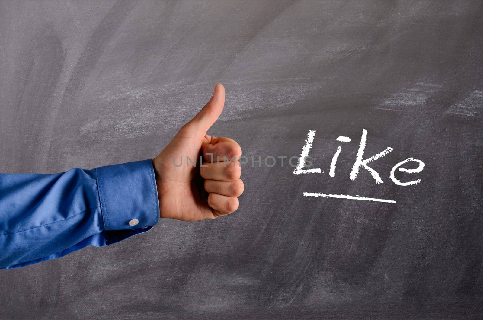 Business man with thumb up on a blackboard