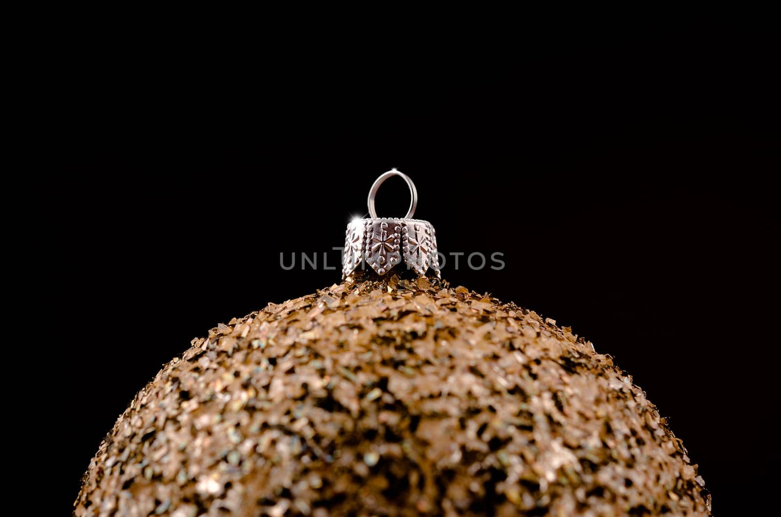 golden Christmas bauble on a dark background