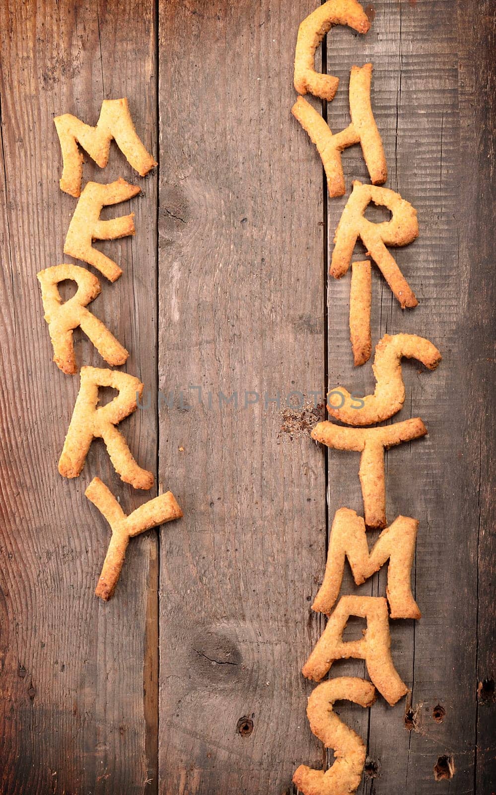 Sweet Merry Christmas cookies on a rustic wooden table