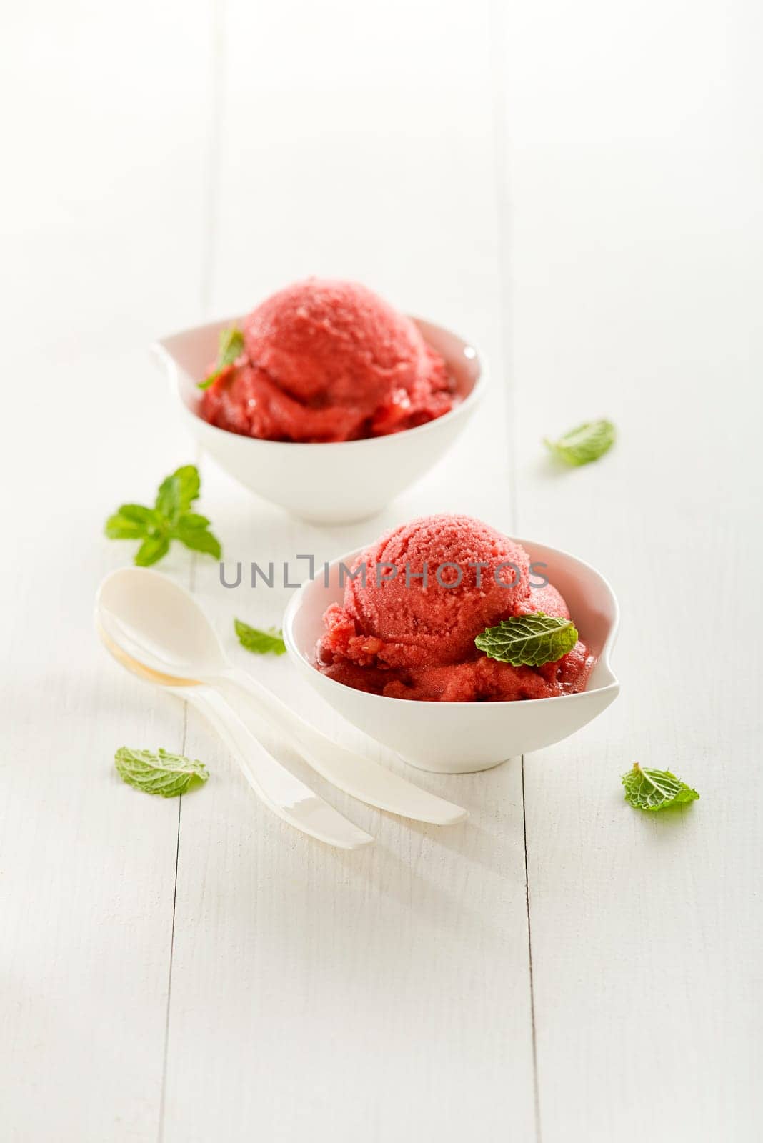 Fresh fruit sorbet ice cream in a white bowl.